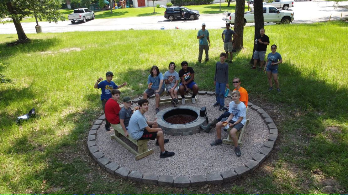 Scouts and adults gathered at an outdoor service project